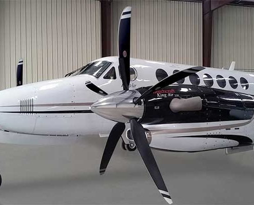 king-air-plane-parked-in-hangar-plane-is-white-with-large-propellers