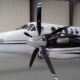 king-air-plane-parked-in-hangar-plane-is-white-with-large-propellers