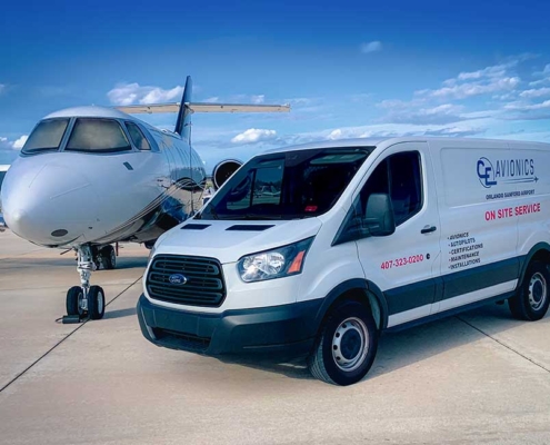 avionics-hangar-showing-parked-ce-avionics-maintenance-van-and-plane-next to-it-with-blue-sky-in-background