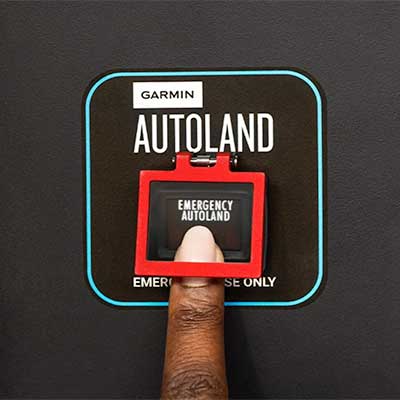 finger-pressing-garmin-autoland-button-to-practice-aviation-safety